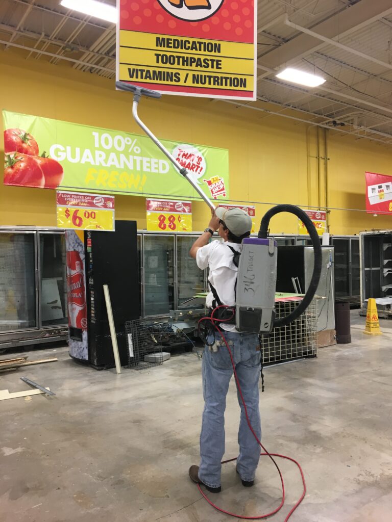 A man cleaning a sign