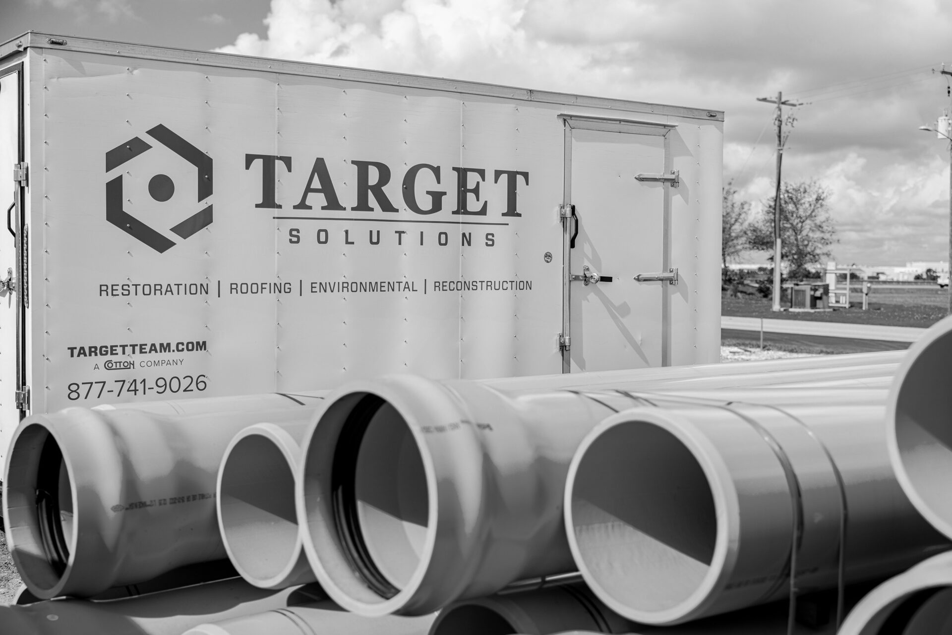 Large pipes in front of a Target Solution trailer
