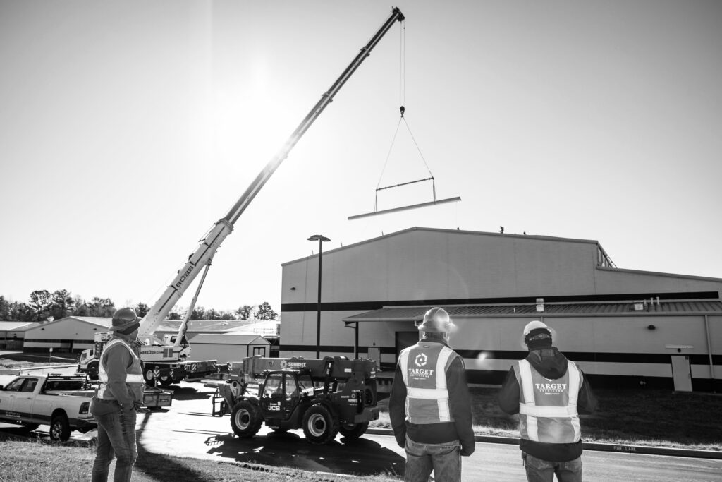 Target Solutions HSE team overseeing high school roof replacement using crane