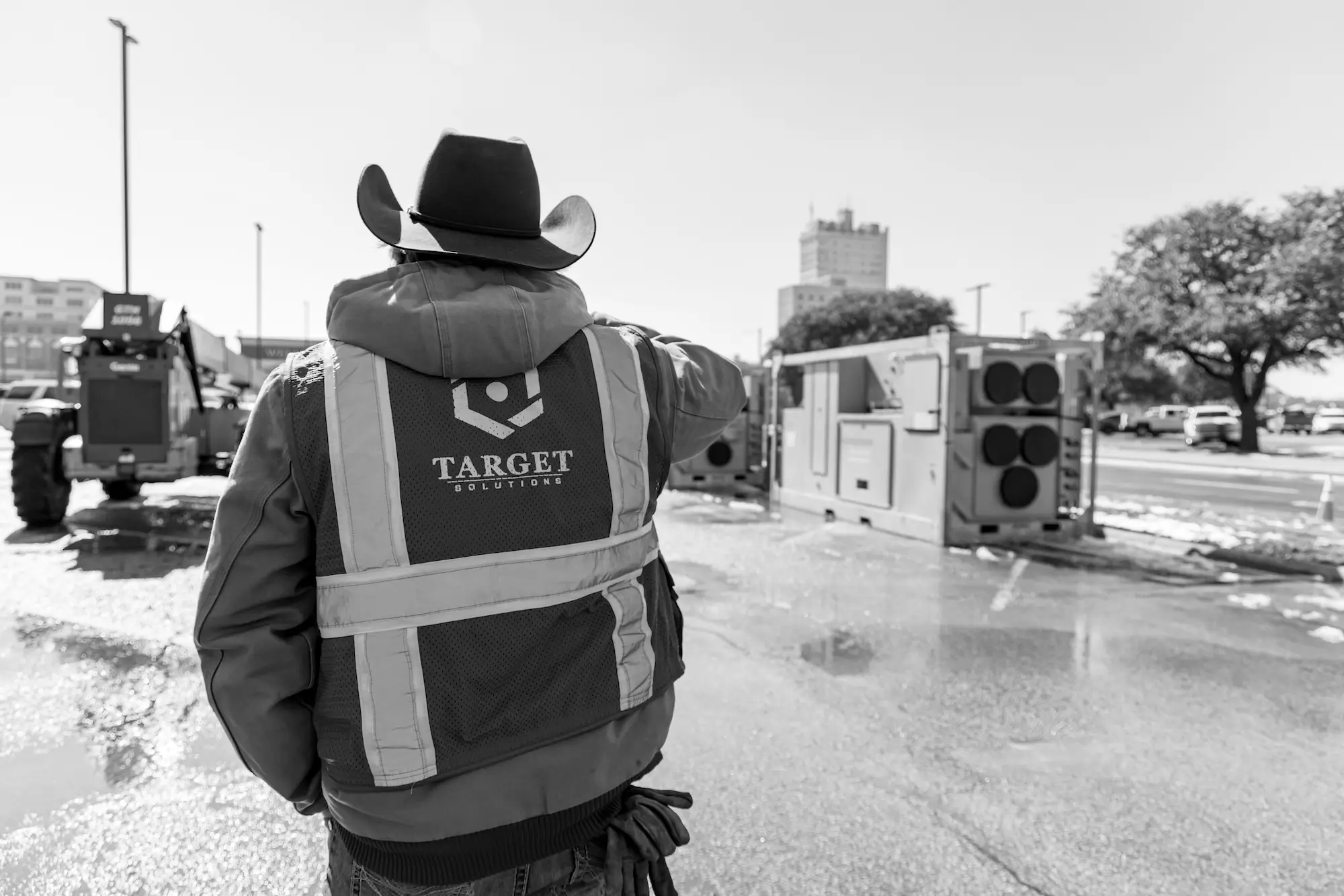 Target professional wearing a cowboy hat looking over a job site