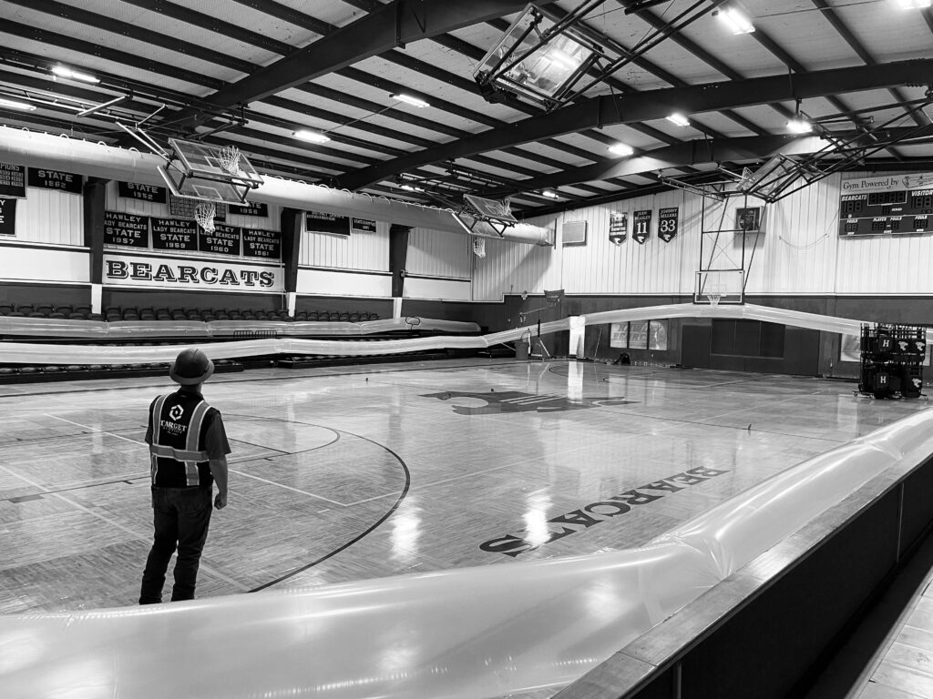 Desiccant dehumidifiers running in high school gym