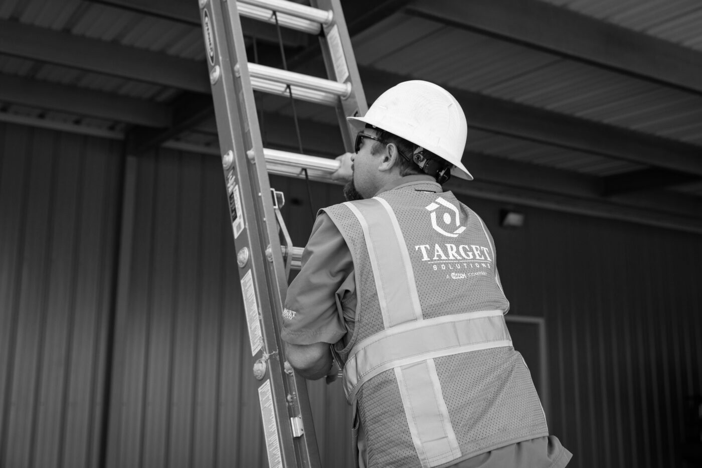 Roofing technician climbing ladder