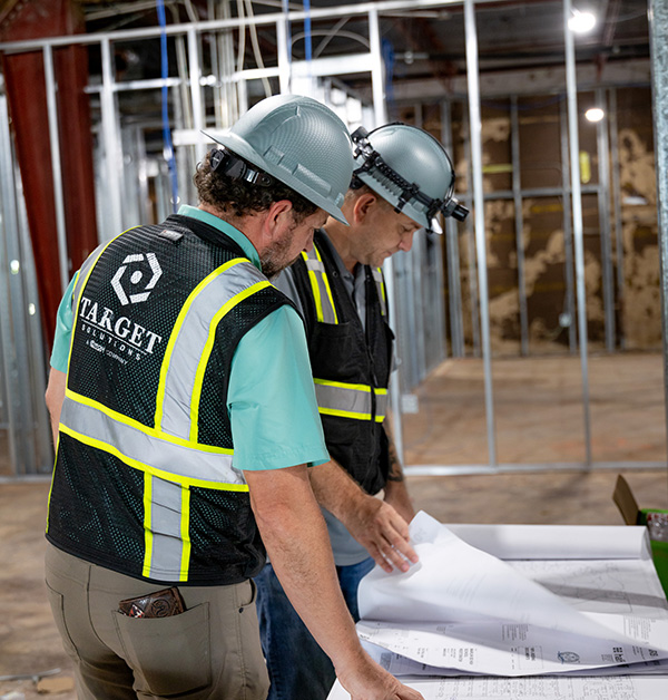 Target solutions reconstruction team looking at construction plans